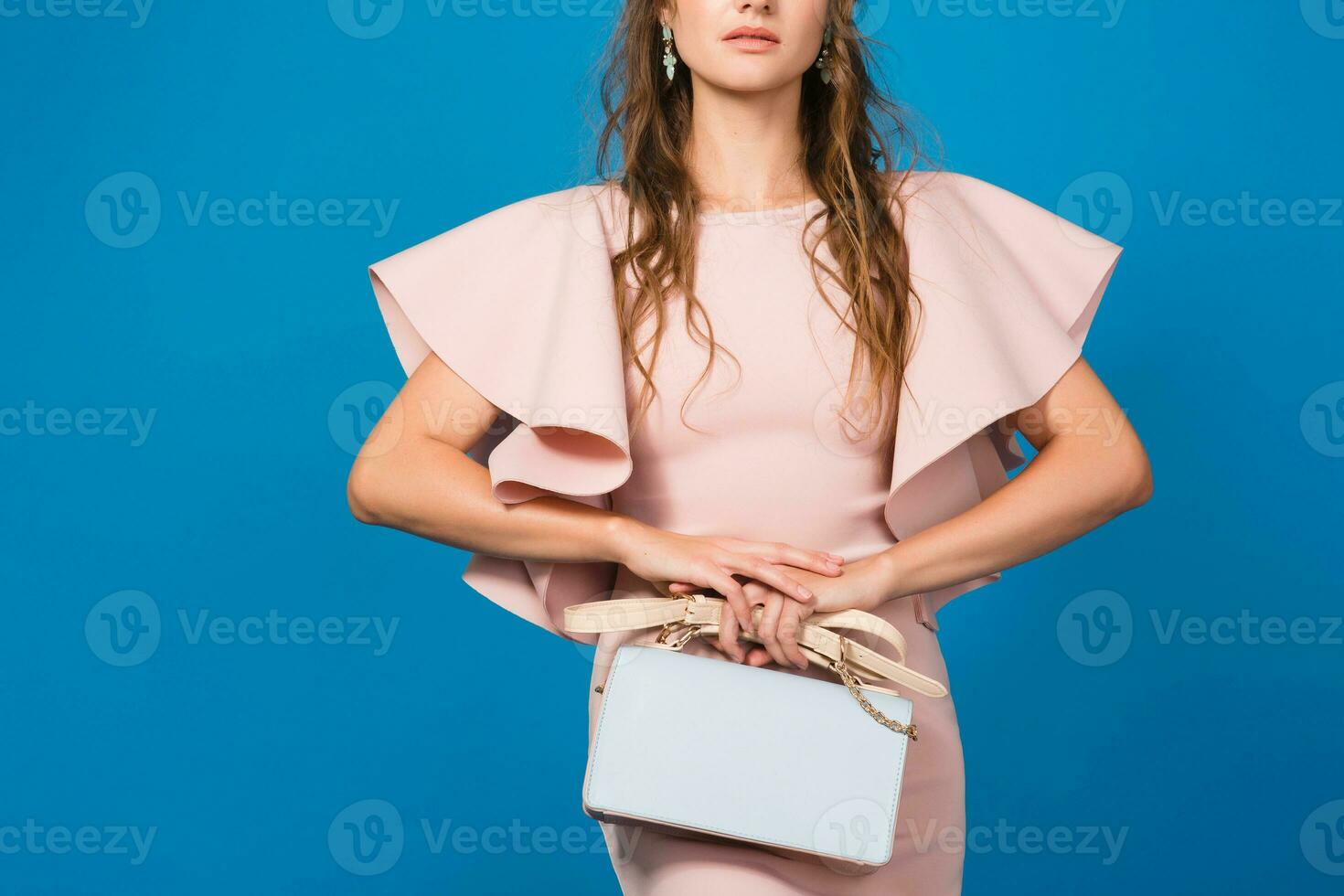 young stylish sexy woman in pink luxury dress, summer fashion trend holding trendy handbag photo