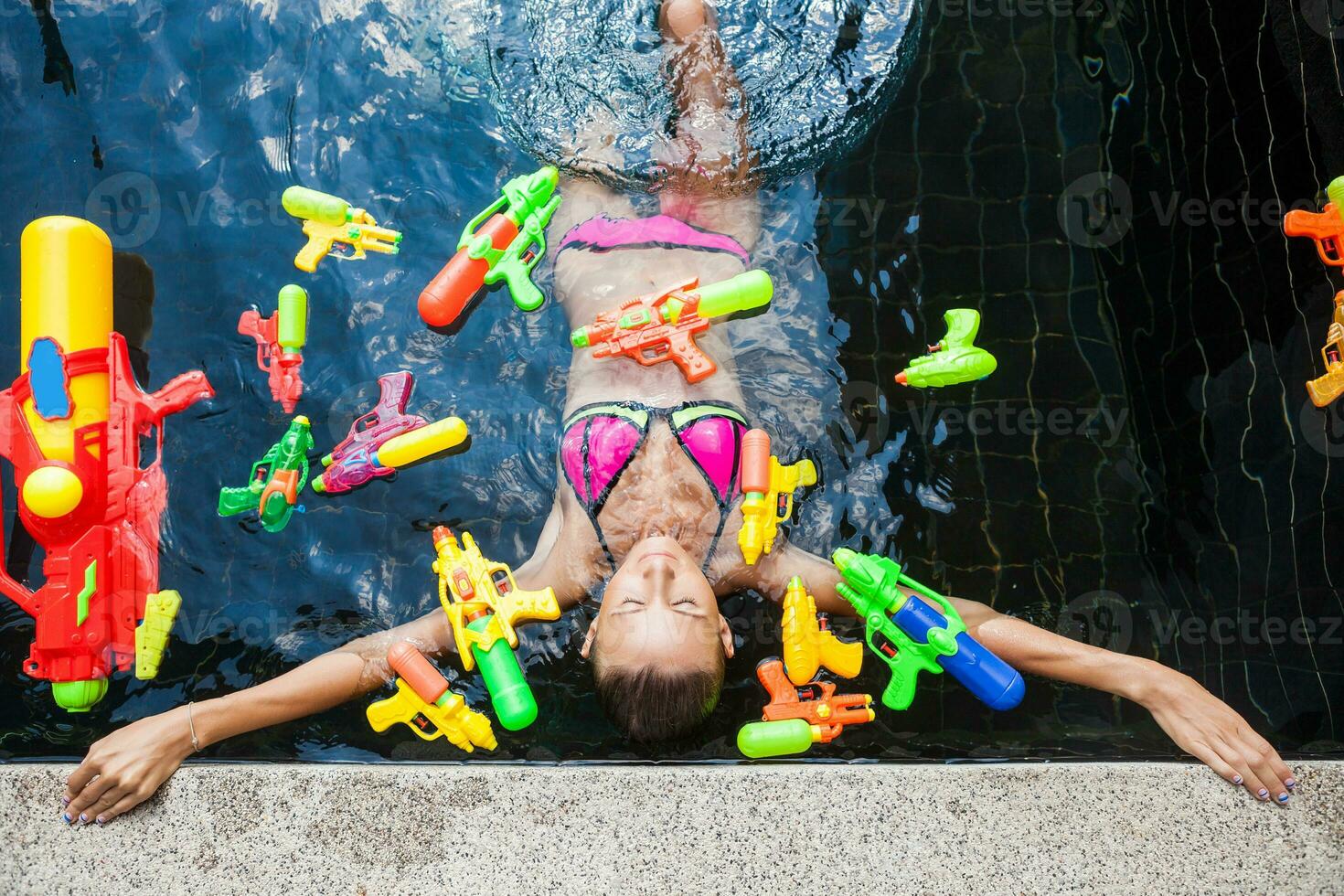 sexy woman in colorful bikini playing having fun at summer summer pool on vacation in Thailand photo