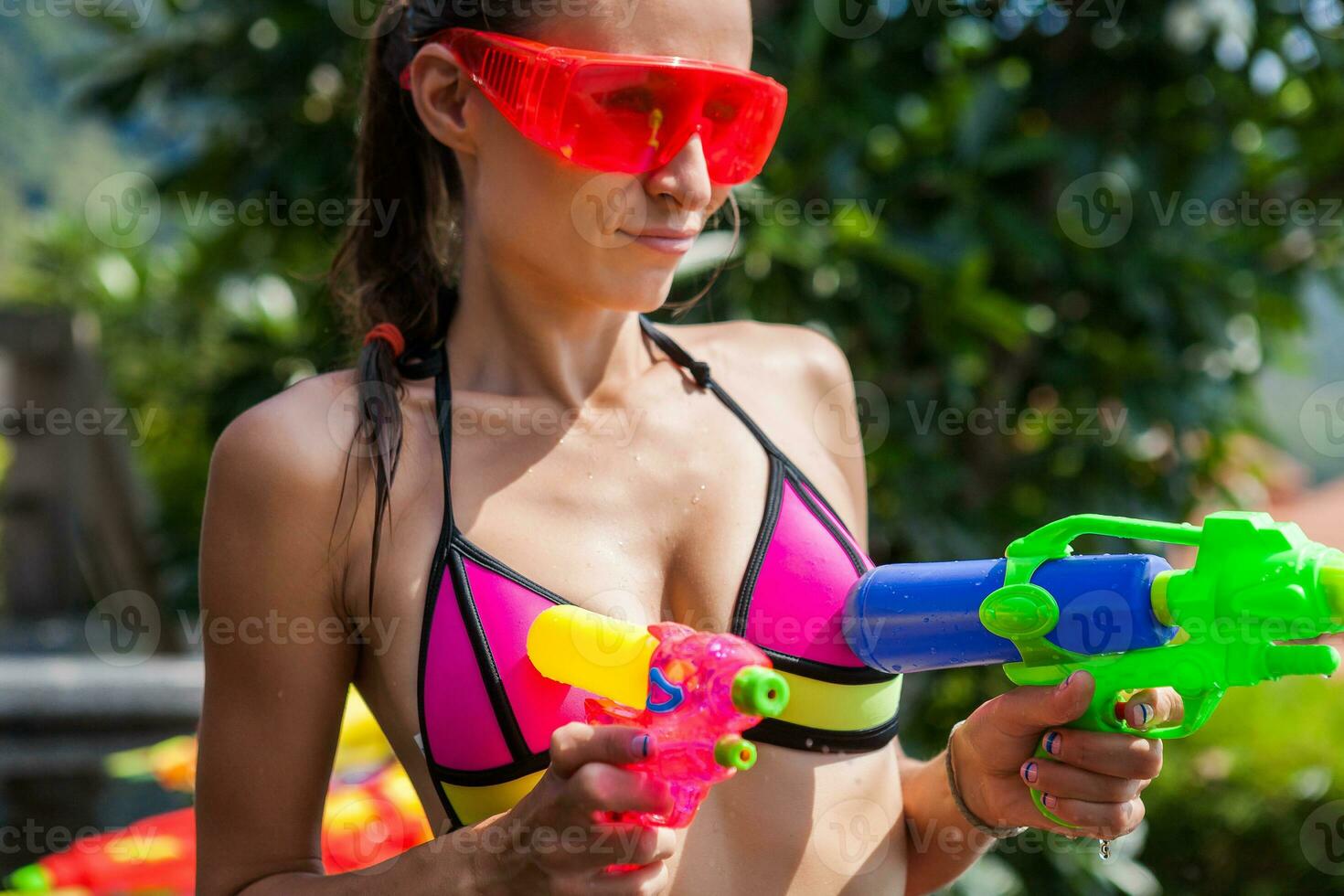 sexy woman in colorful bikini playing having fun at summer summer pool on vacation in Thailand photo