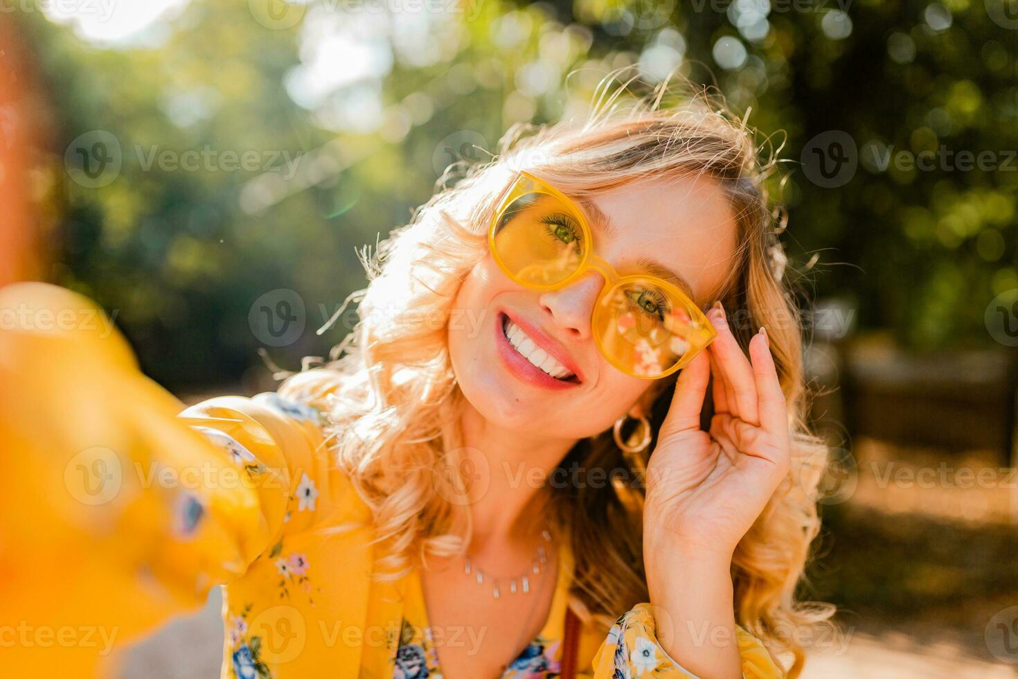 attractive woman walking in street in yellow shirt photo