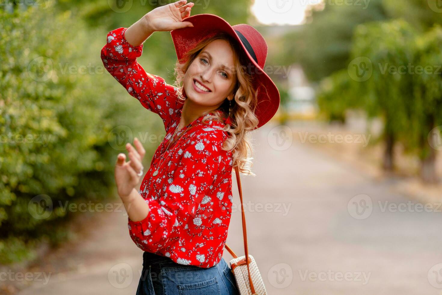 attractive stylish blond smiling woman in straw red hat and blouse summer fashion photo
