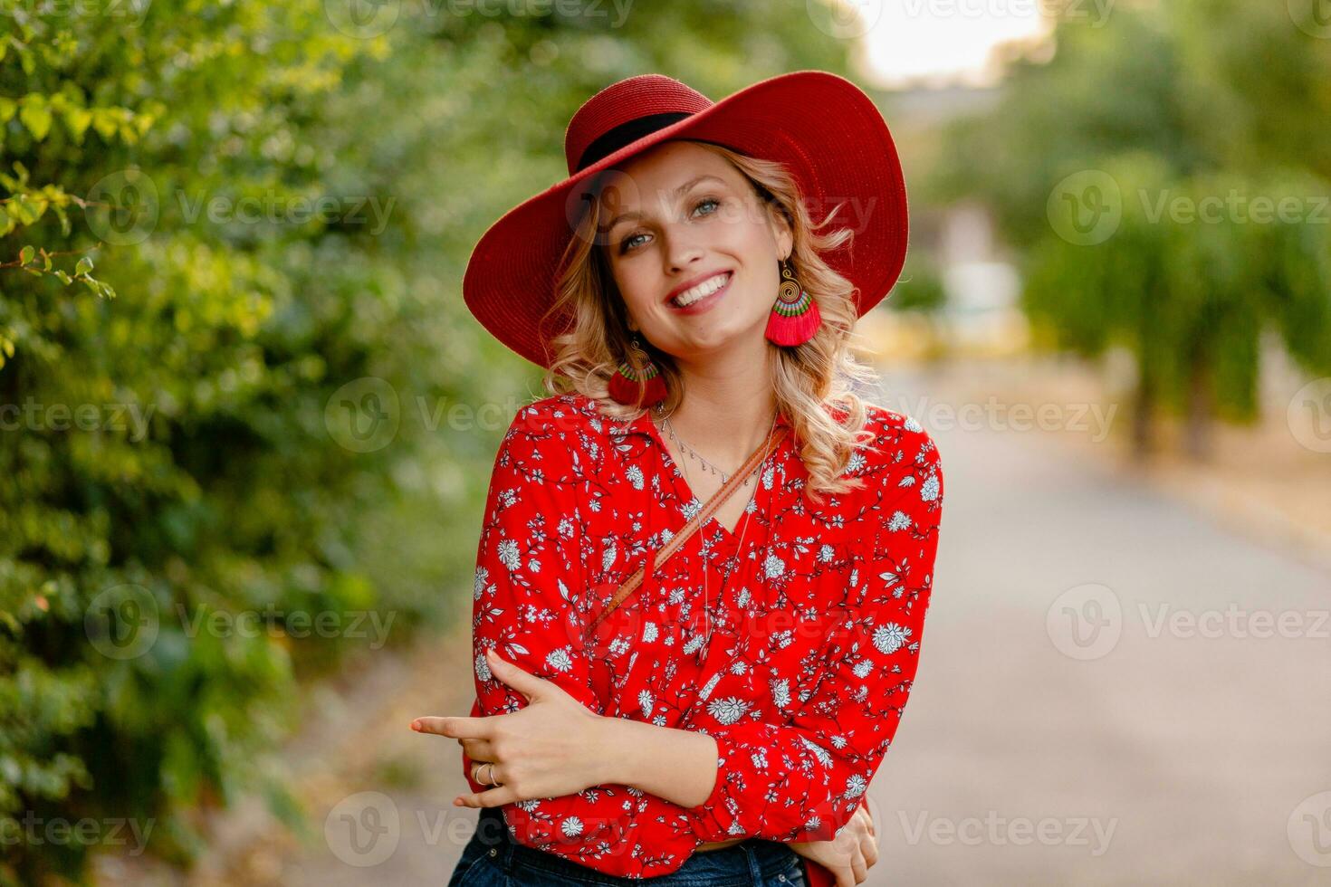 attractive stylish blond smiling woman in straw red hat and blouse summer fashion photo