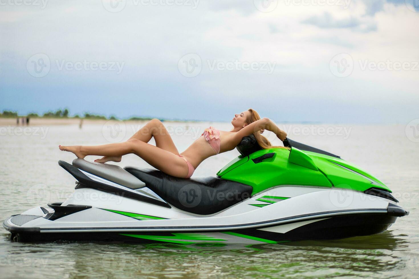 sexy woman in bikini on water scooter in sea summer style photo