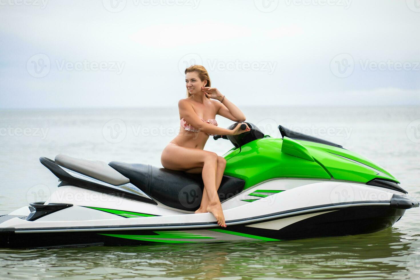 sexy woman in bikini on water scooter in sea summer style photo