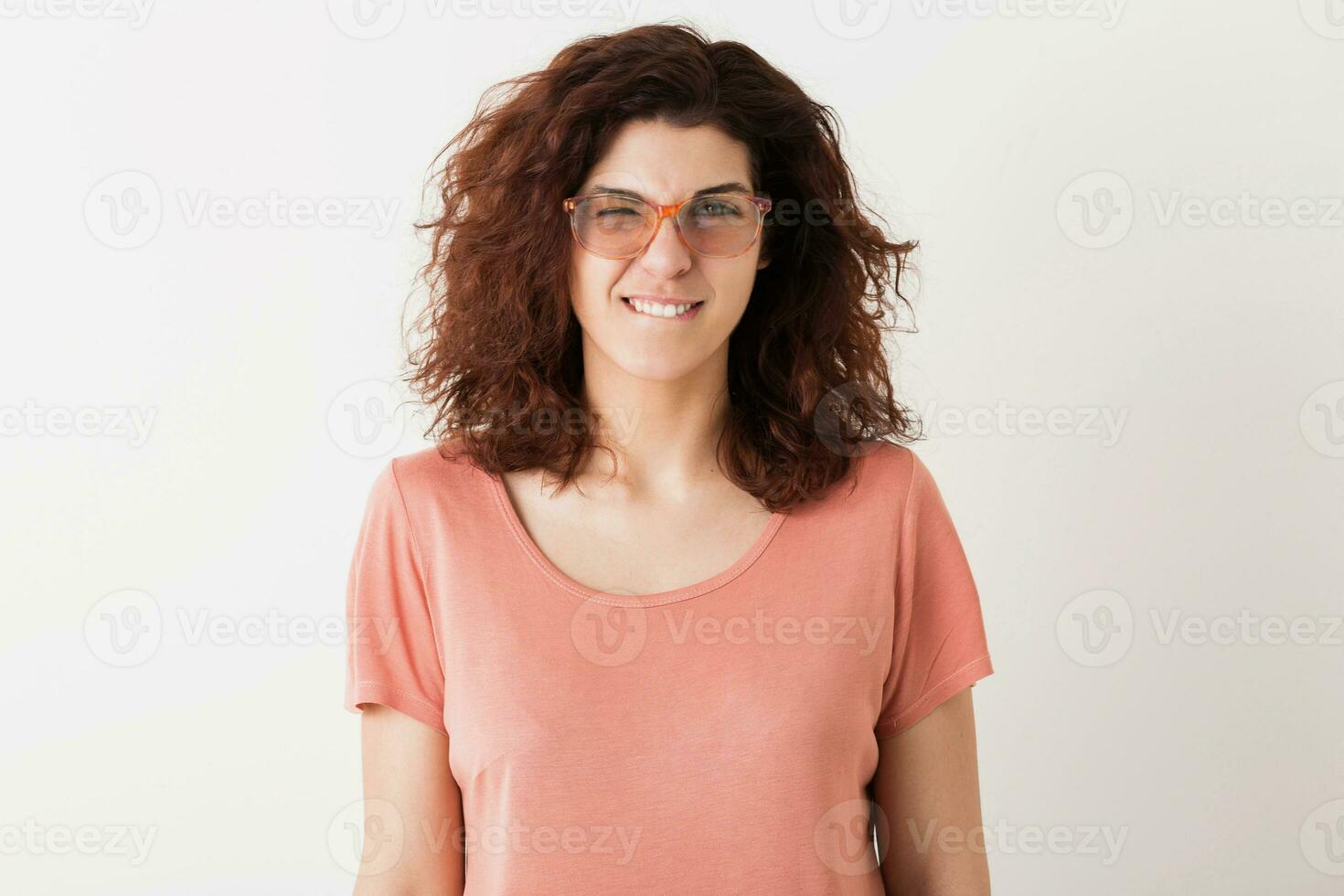 portrait of young natural looking smiling happy hipster pretty woman in pink shirt photo