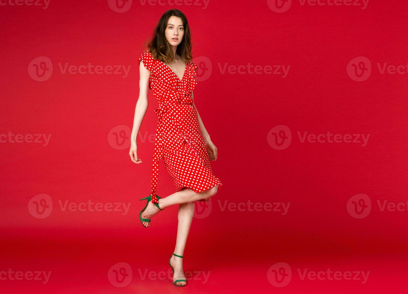 stylish woman in summer fashion trend dress on red background photo