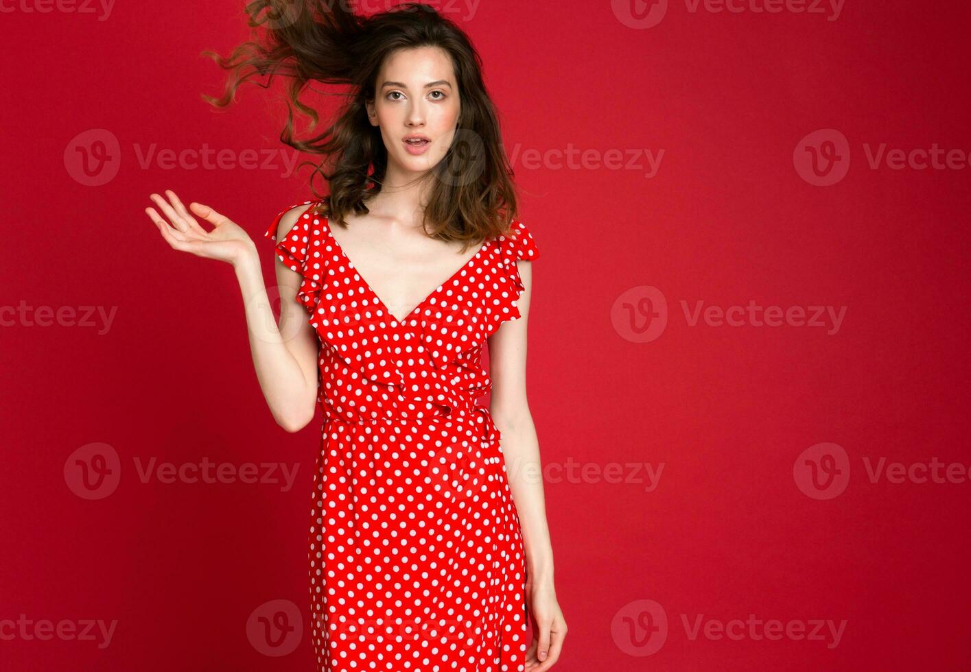 stylish woman in summer fashion trend dress on red background photo