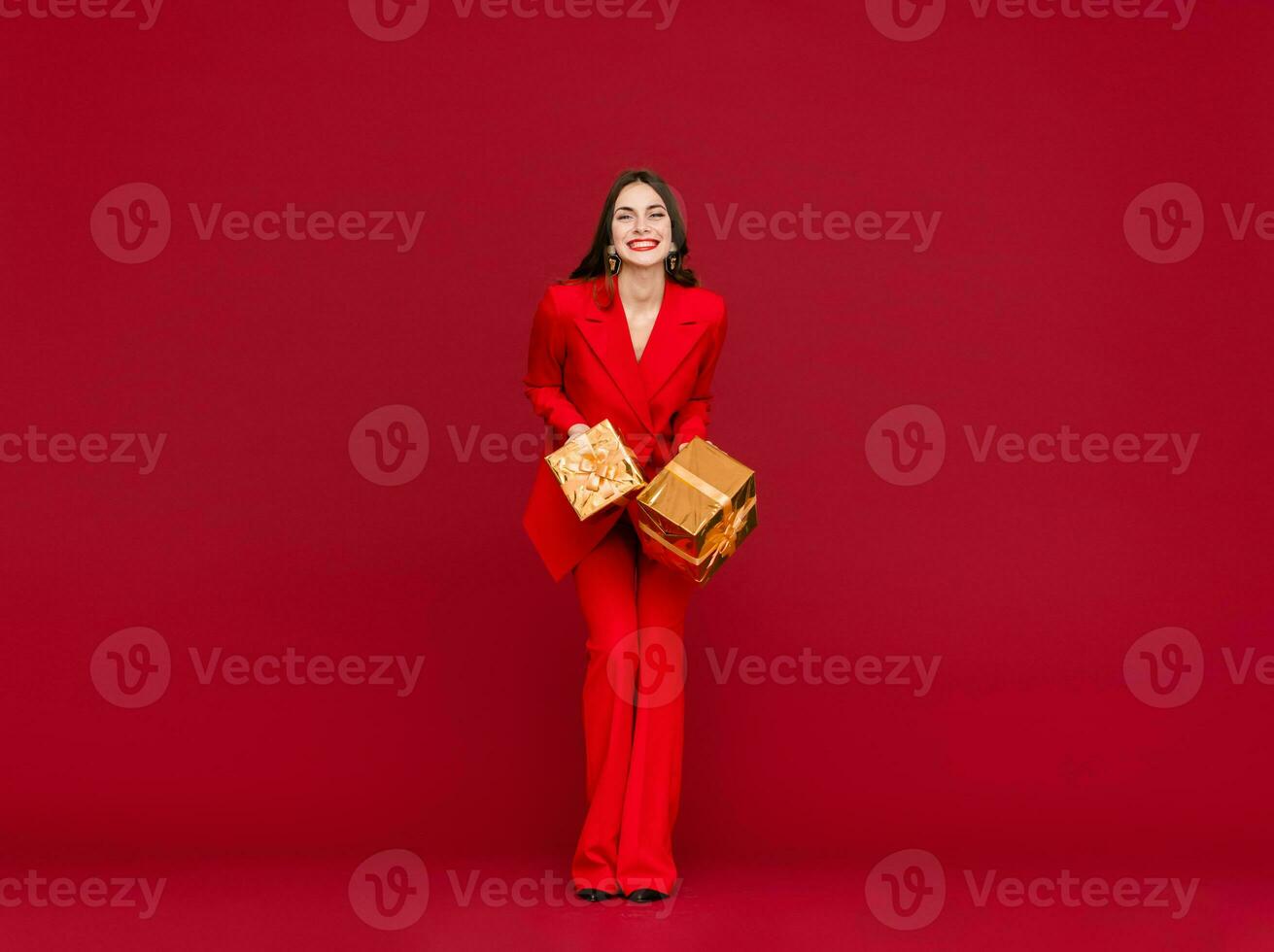 attractive woman celebrating Christmas on red background photo