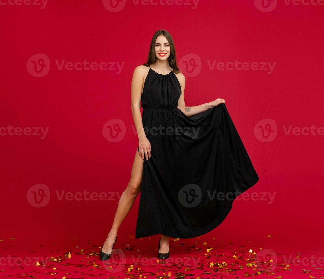 attractive woman celebrating Christmas on red background photo