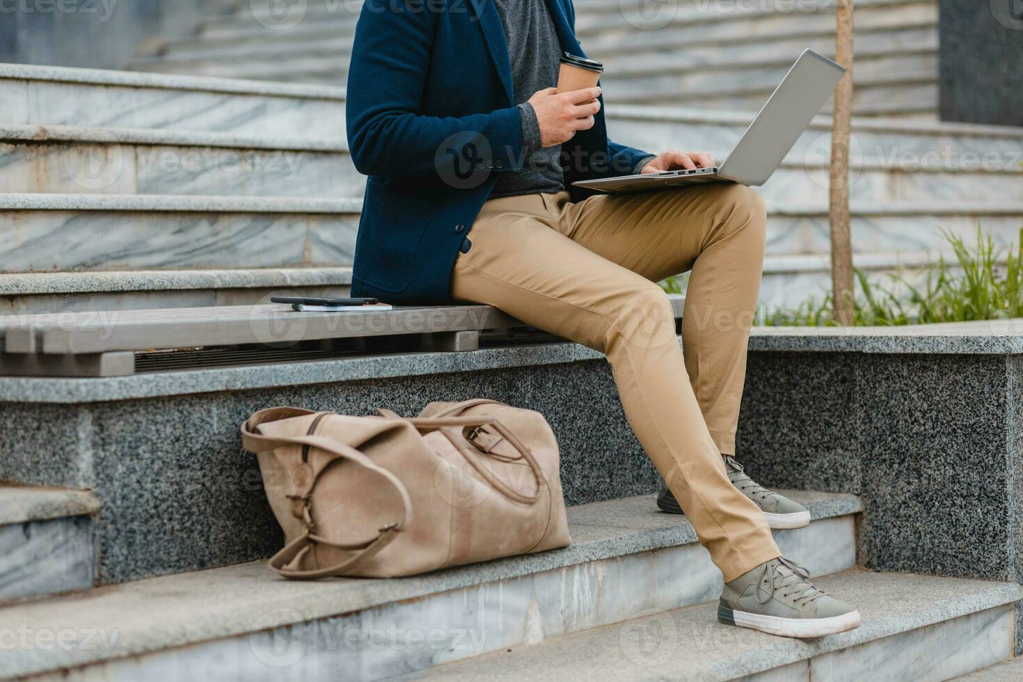 handsome busy bearded man working in park photo