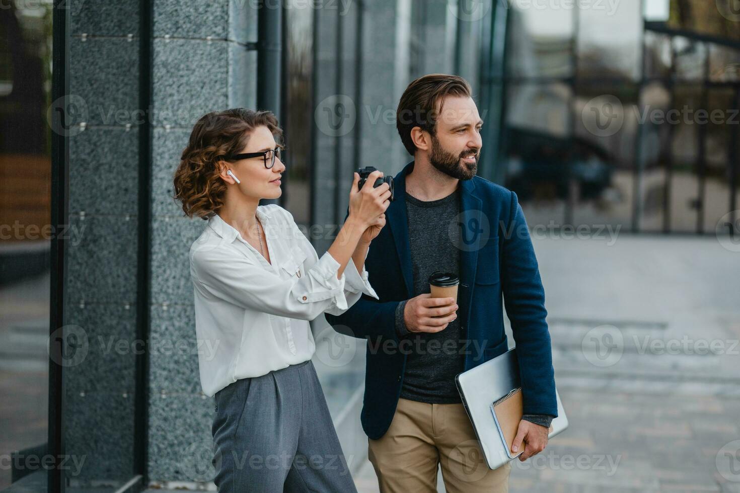 man and woman business partners working together in park photo