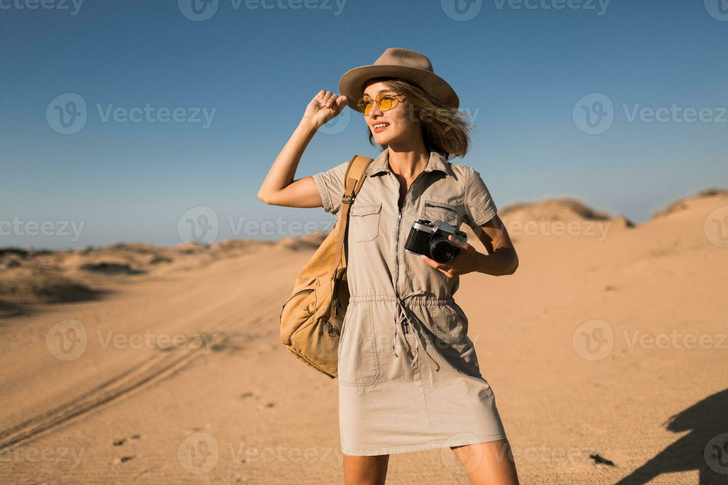 woman in desert walking on safari photo