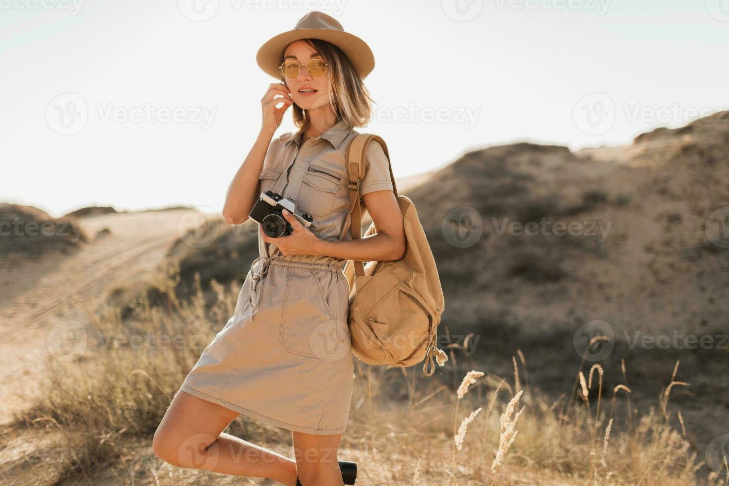 woman in desert walking on safari photo