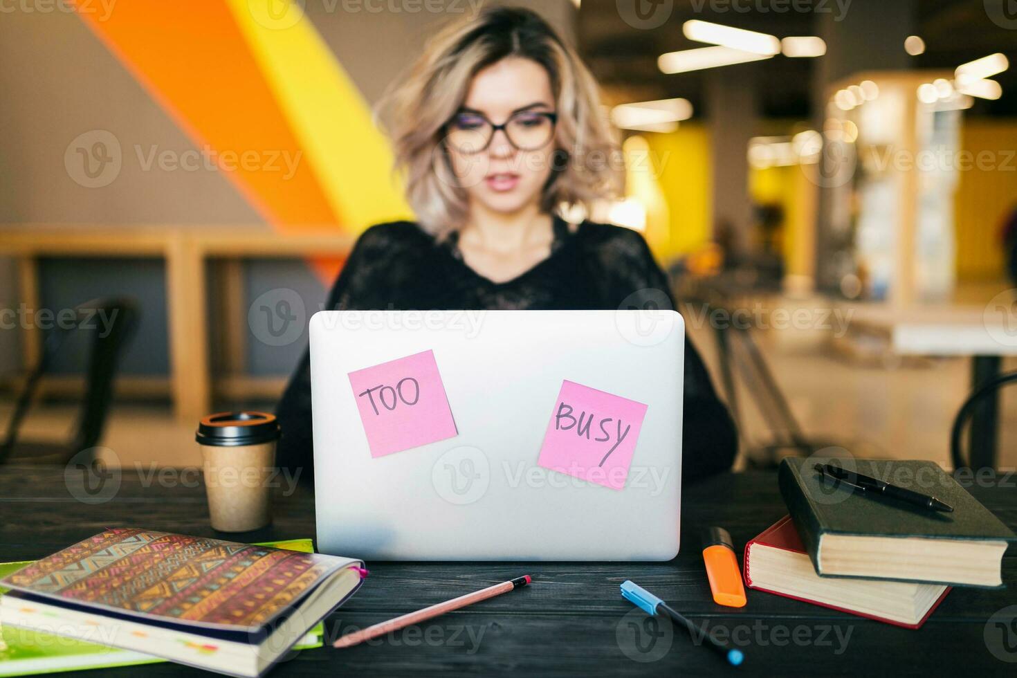 young woman working on laptop in co-working office photo
