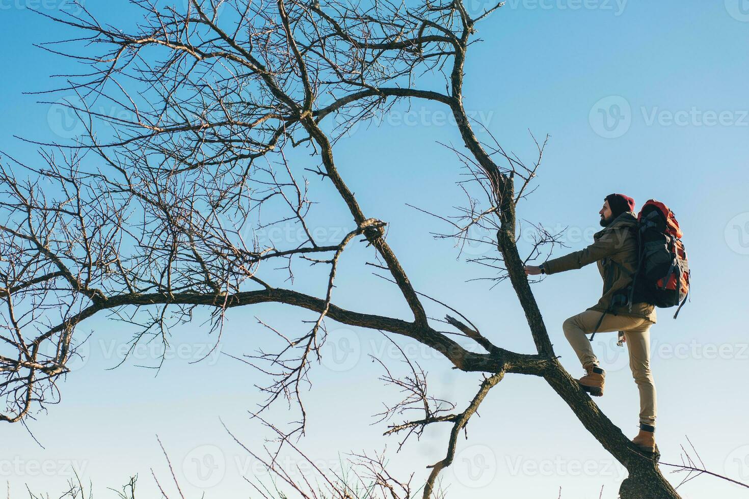 young hipster man traveling with backpack in cold season photo