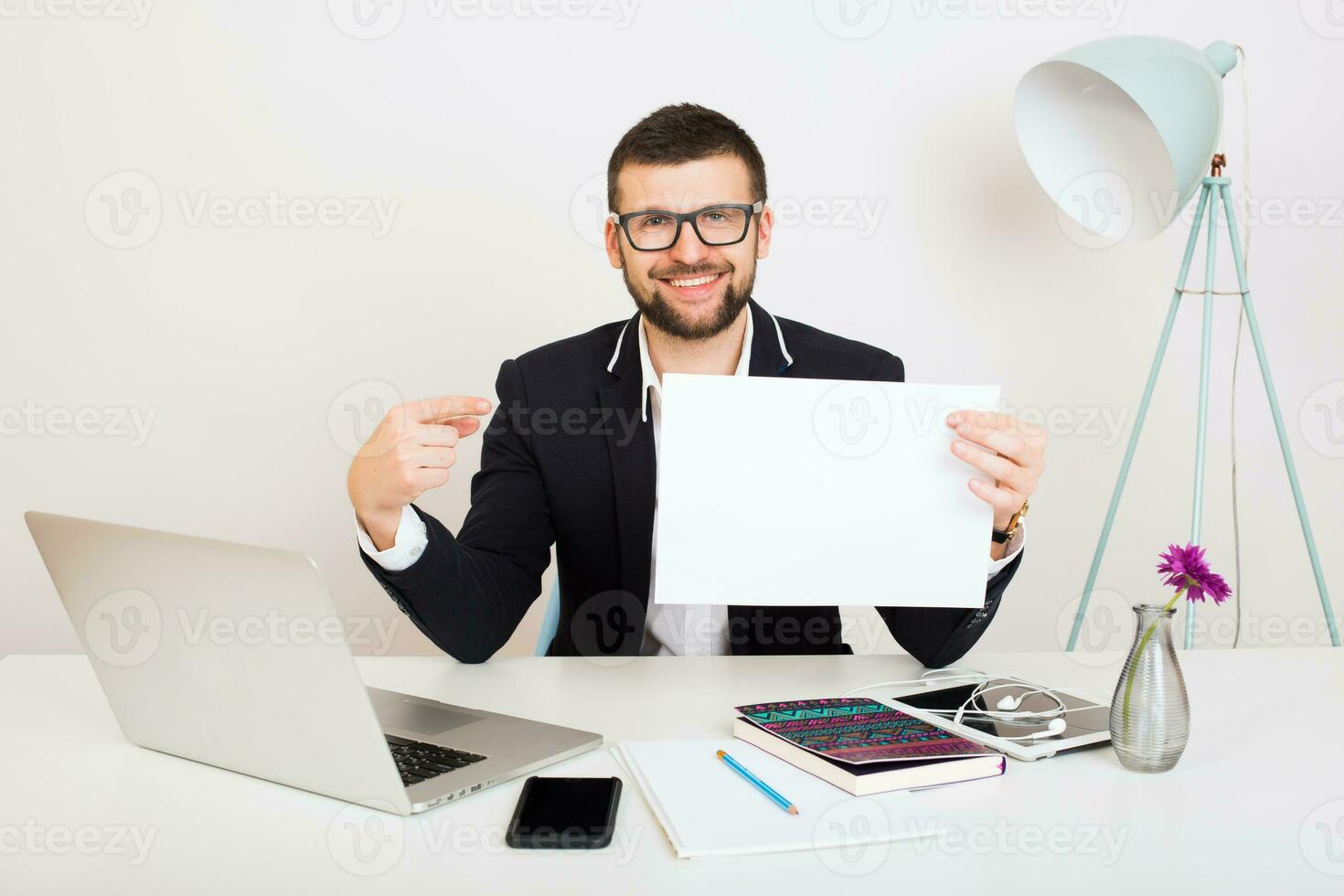 young handsome stylish hipster man in black jacket working at office table photo