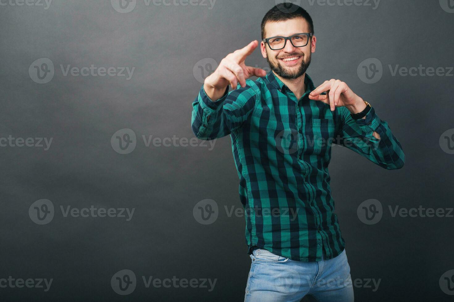 young handsome hipster bearded man on grey background photo