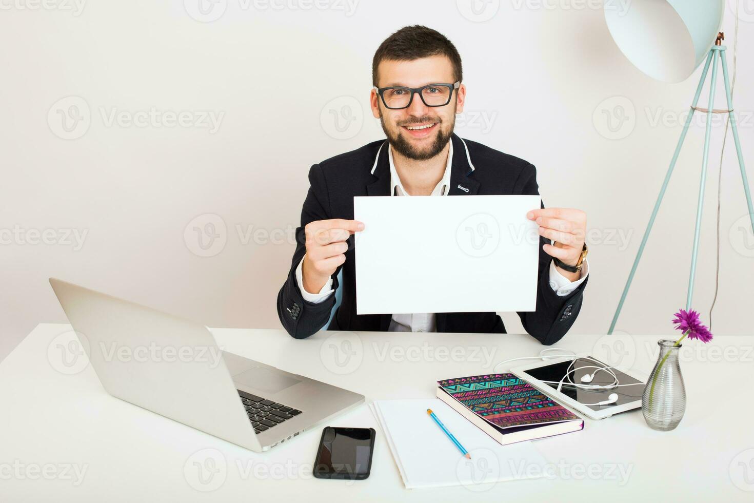 young handsome stylish hipster man in black jacket working at office table, business style photo
