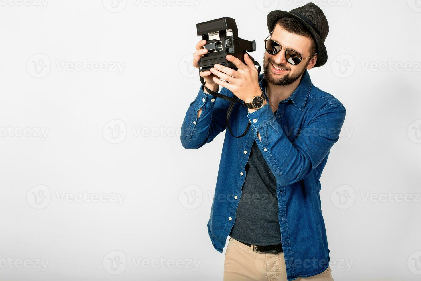 young handsome smiling happy man holding vintage photo camera