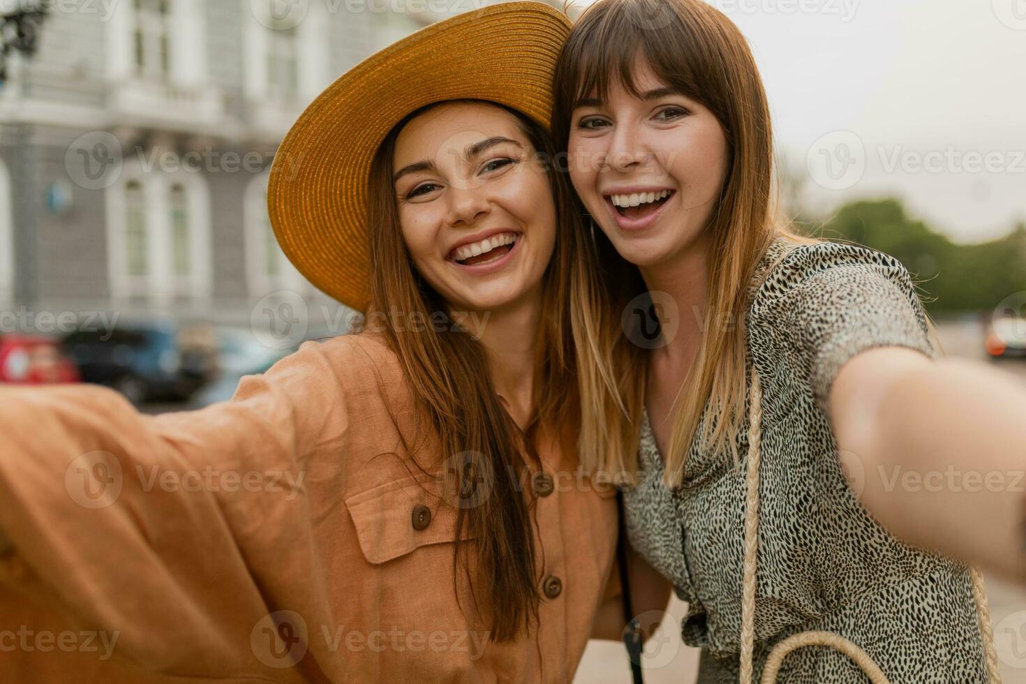 stylish young women traveling together photo