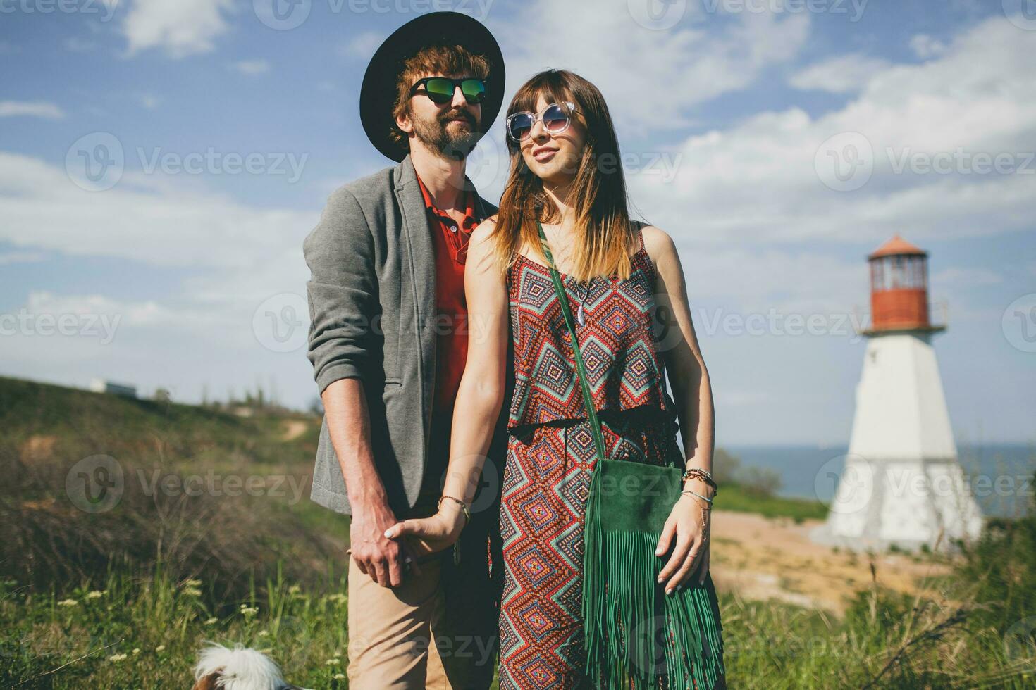 laughing young hipster couple indie style in love walking in countryside photo