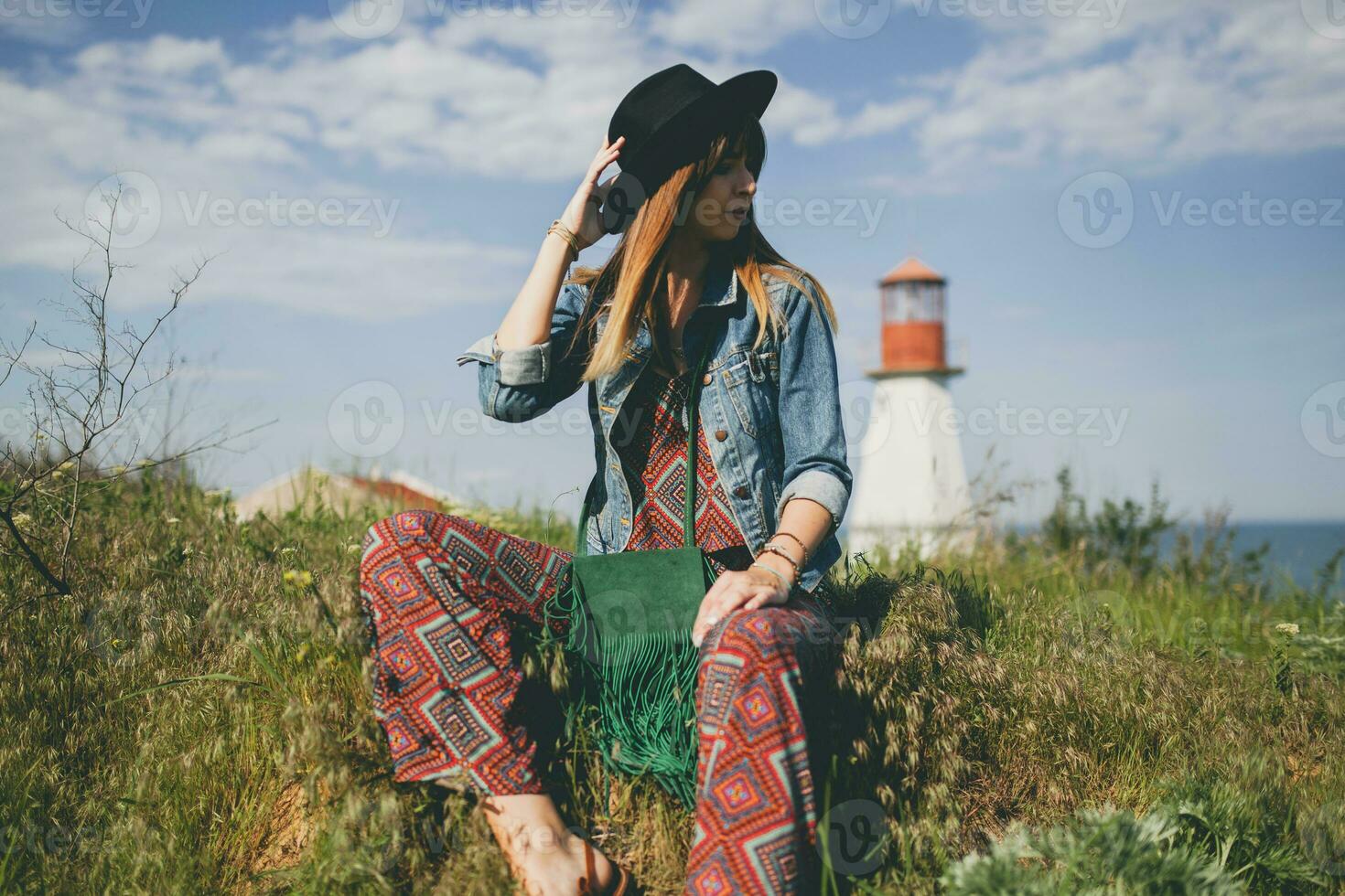 young woman in nature, lighthouse denim jacket, black hat, summer, stylish accessories photo