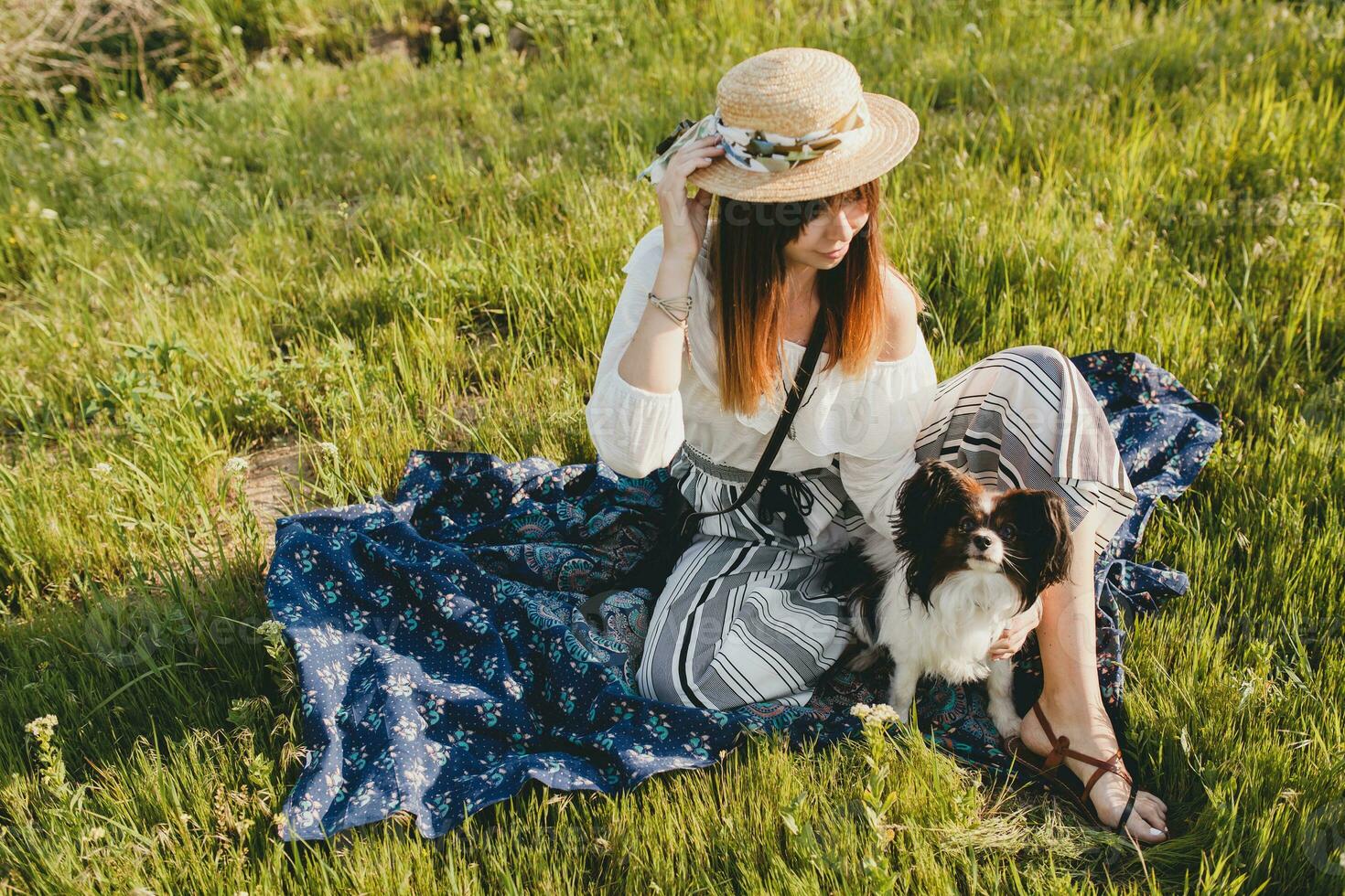 pretty stylish woman in countryside, holding a dog photo