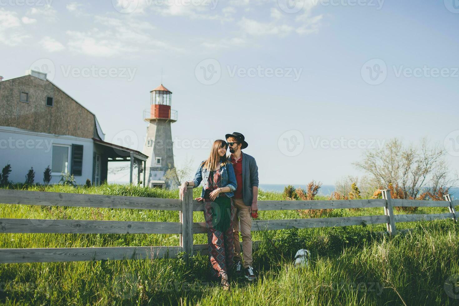 young stylish hipster couple in love walking in countryside photo