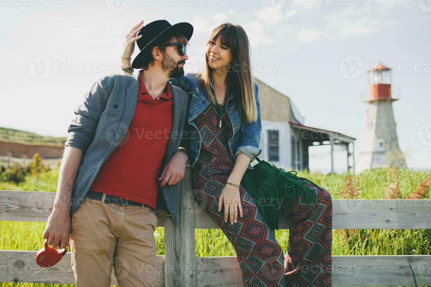 young stylish hipster couple in love walking in countryside photo