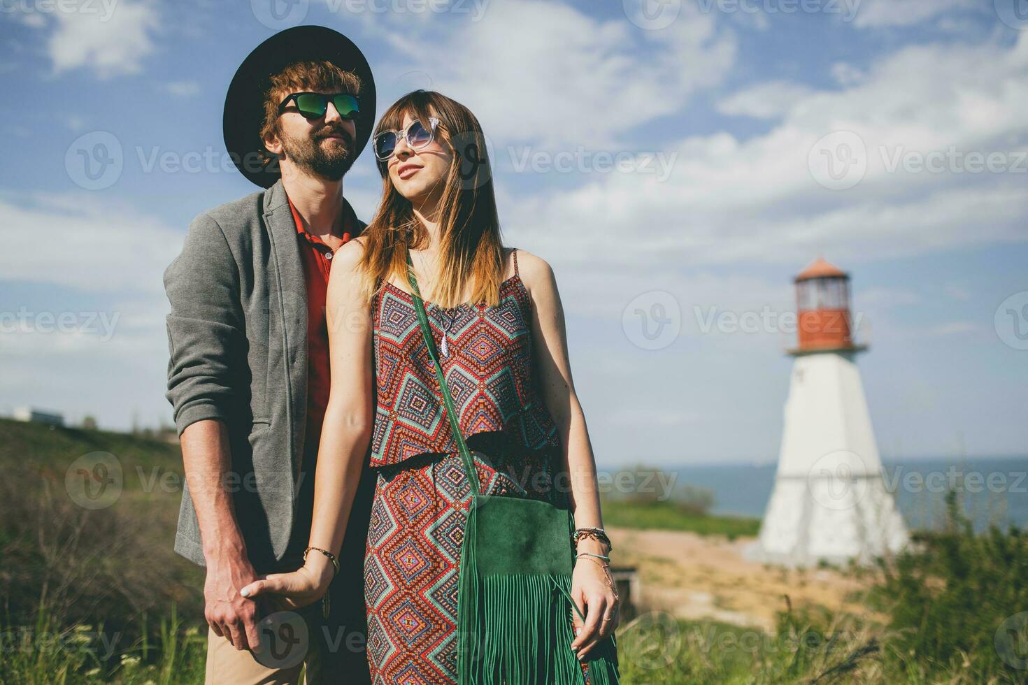 smiling holding hands young hipster couple indie style in love walking in countryside photo