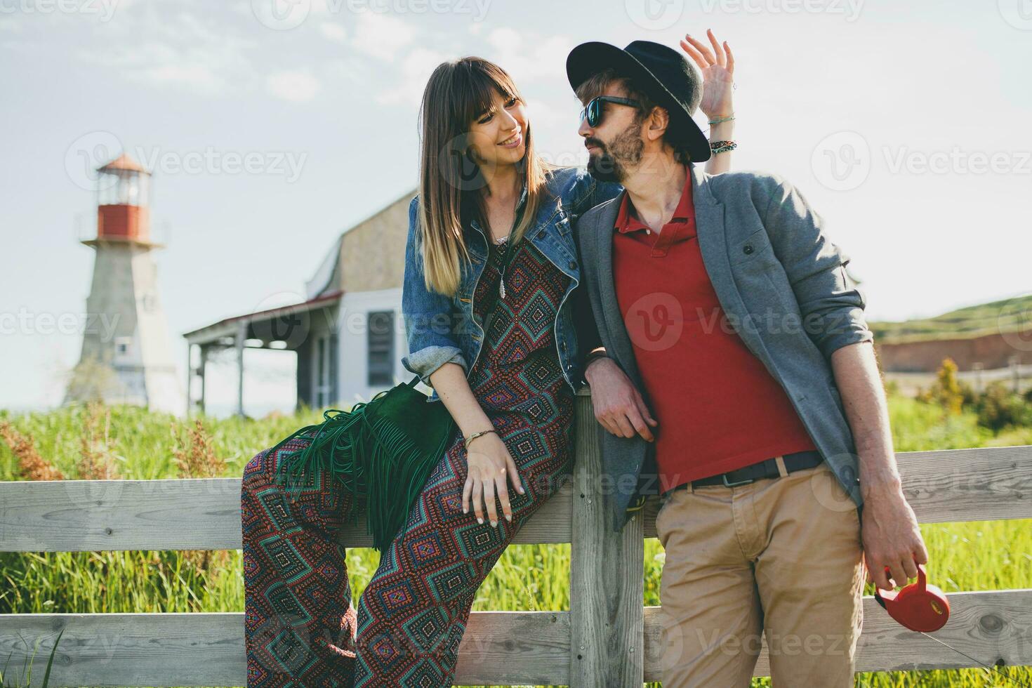 romantic young hipster couple indie style in love walking in countryside photo