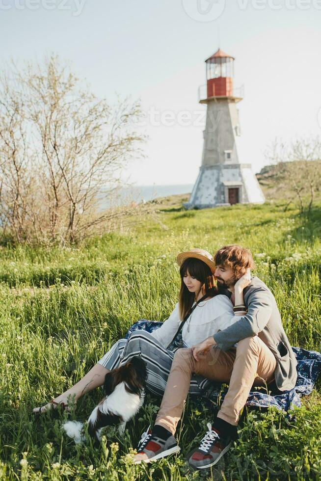 stylish hipster couple in love walking with dog in countryside photo