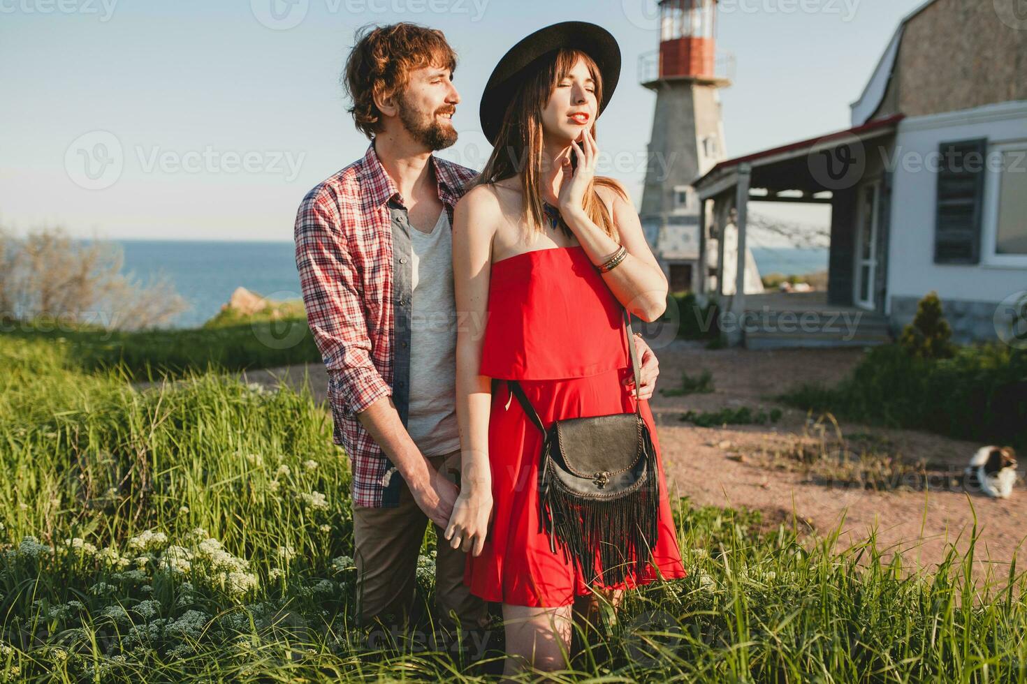 embracing young stylish couple in love in countryside photo