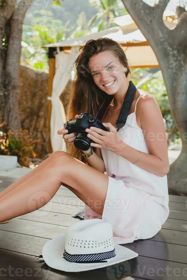 young natural beautiful woman in pale gown, tropical vacation photo