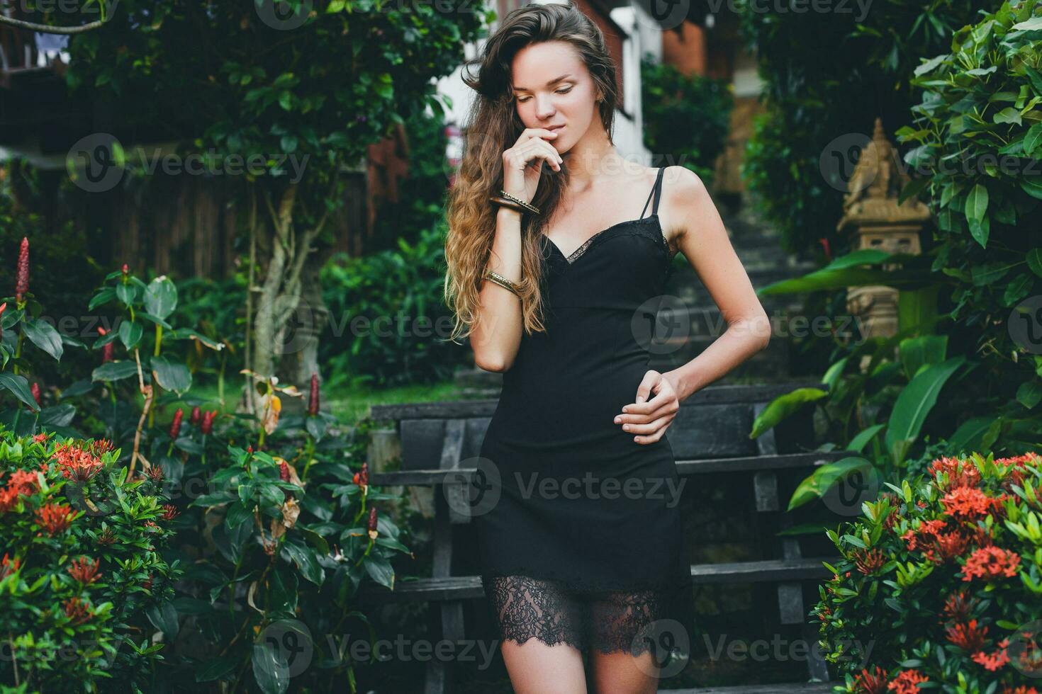 young beautiful woman in tropical garden photo