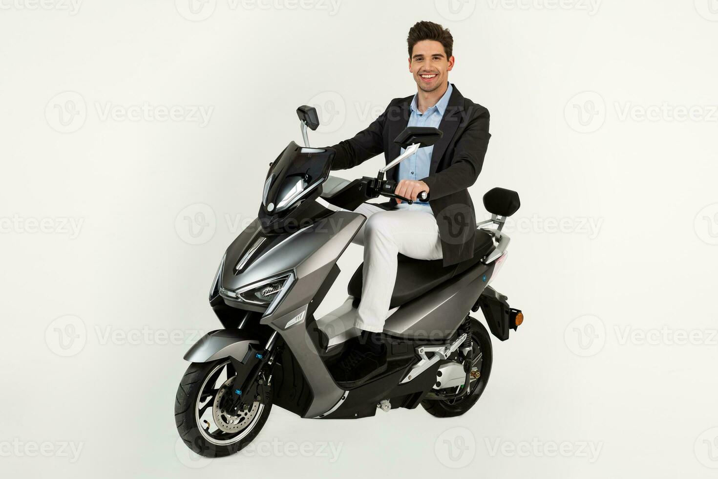 handsome man riding on electic motorbike scooter isolated on white studio background photo