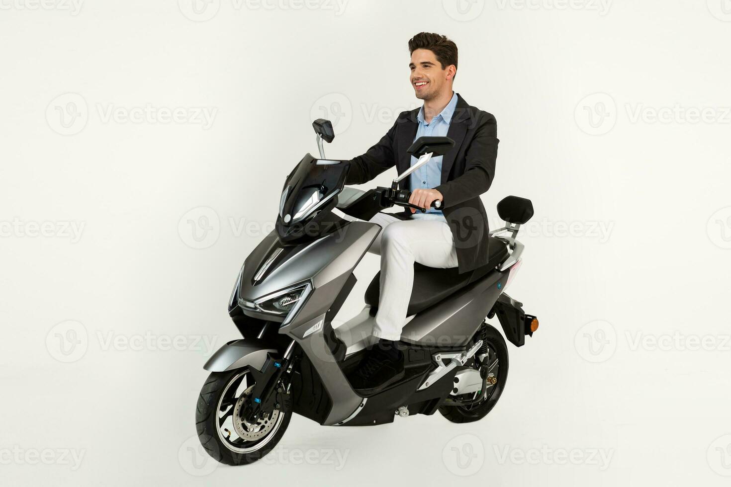 handsome man riding on electic motorbike scooter isolated on white studio background photo