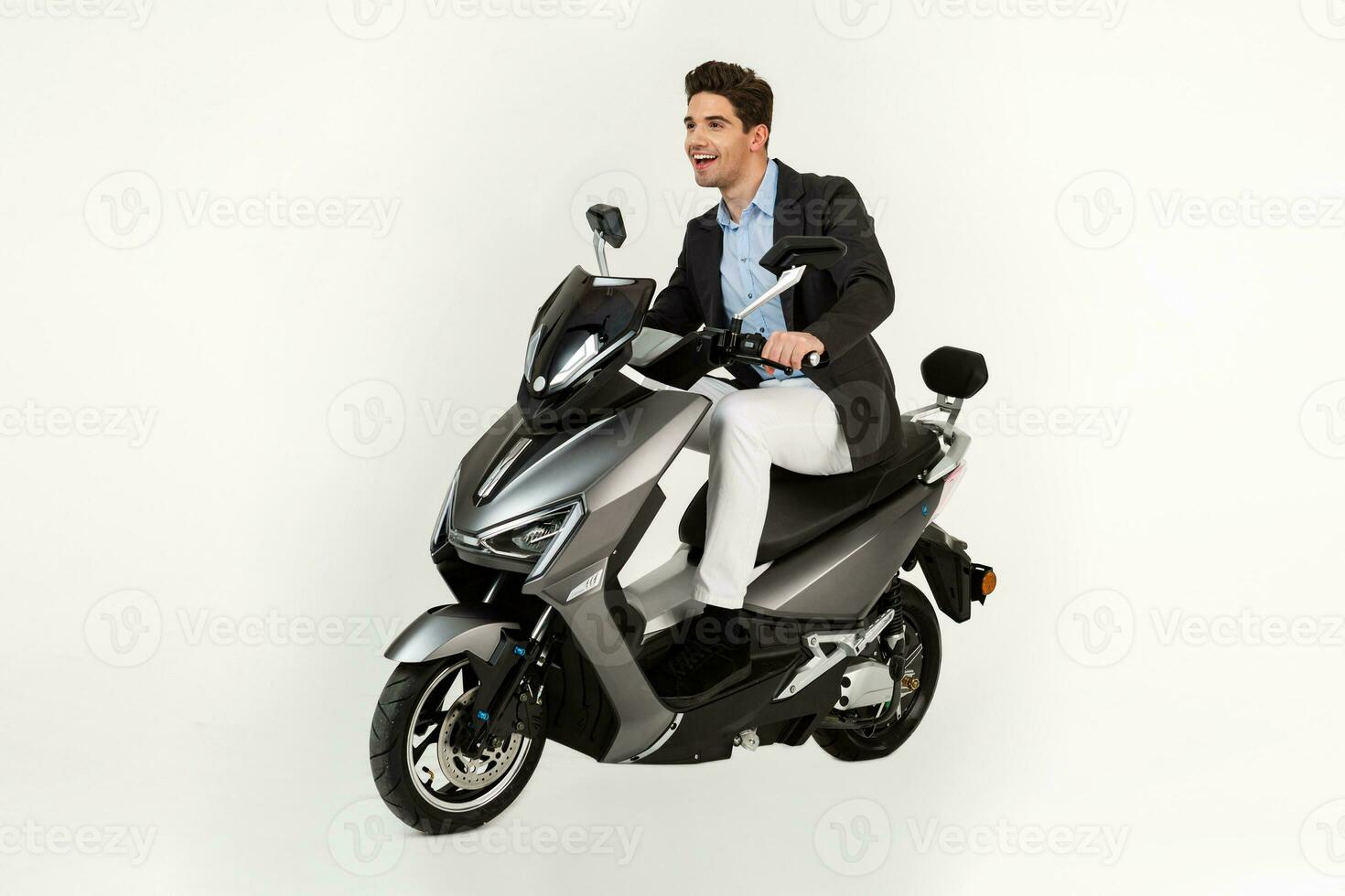 handsome man riding on electic motorbike scooter isolated on white studio background photo
