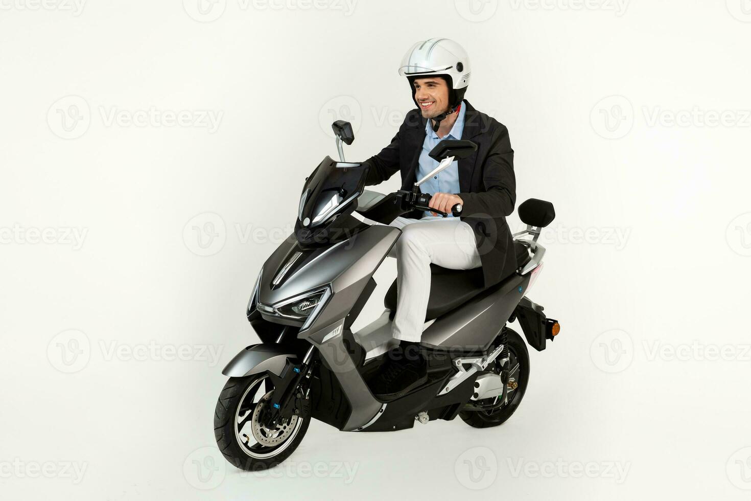 handsome man riding on electic motorbike scooter isolated on white studio background photo