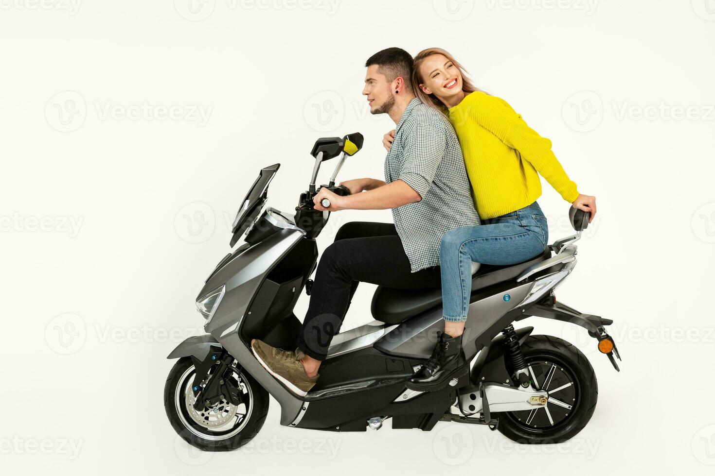 young attractive couple riding an electric motorbike scooter happy having fun together photo