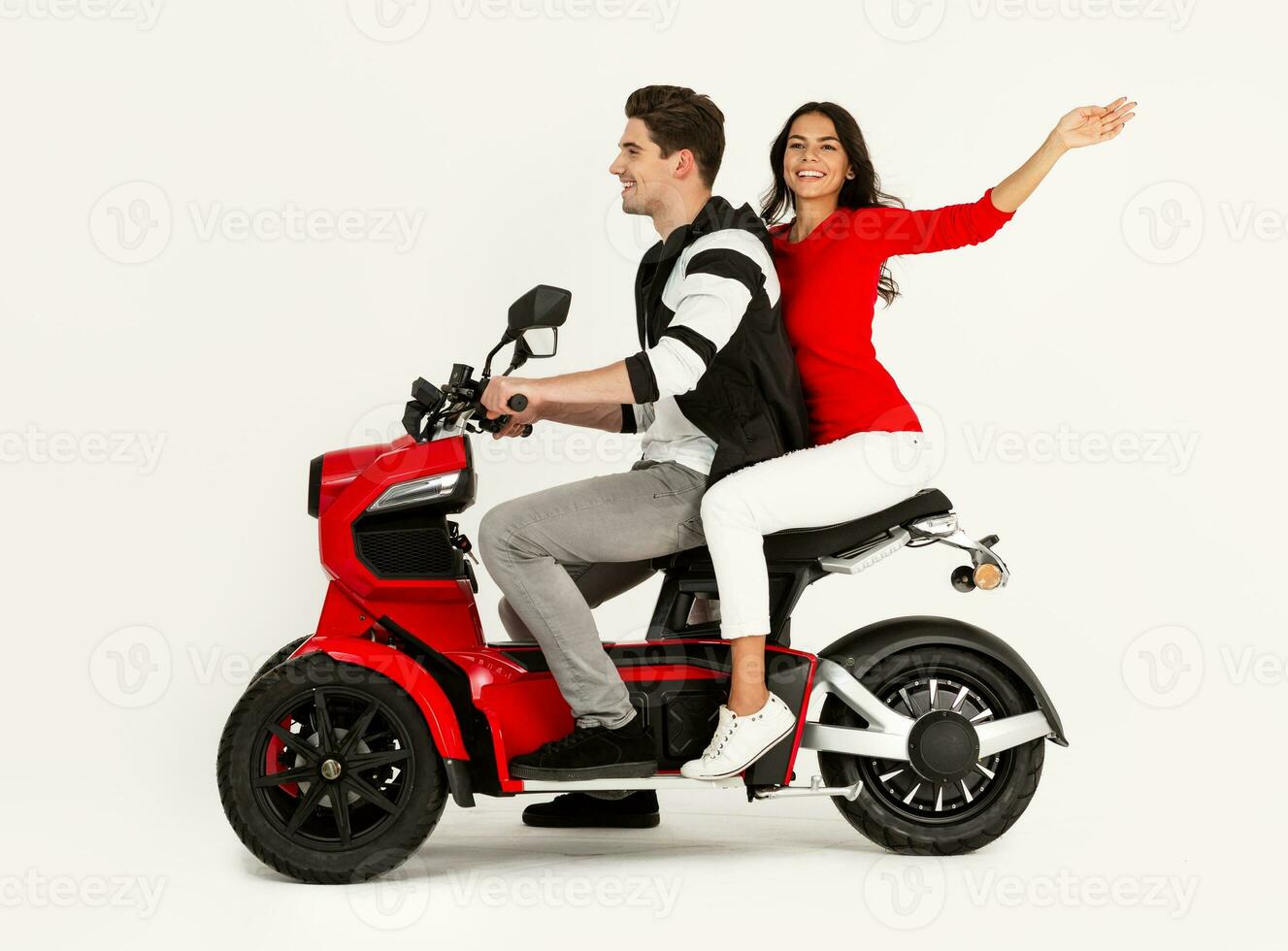 young attractive couple riding an electric motorbike scooter happy having fun together photo