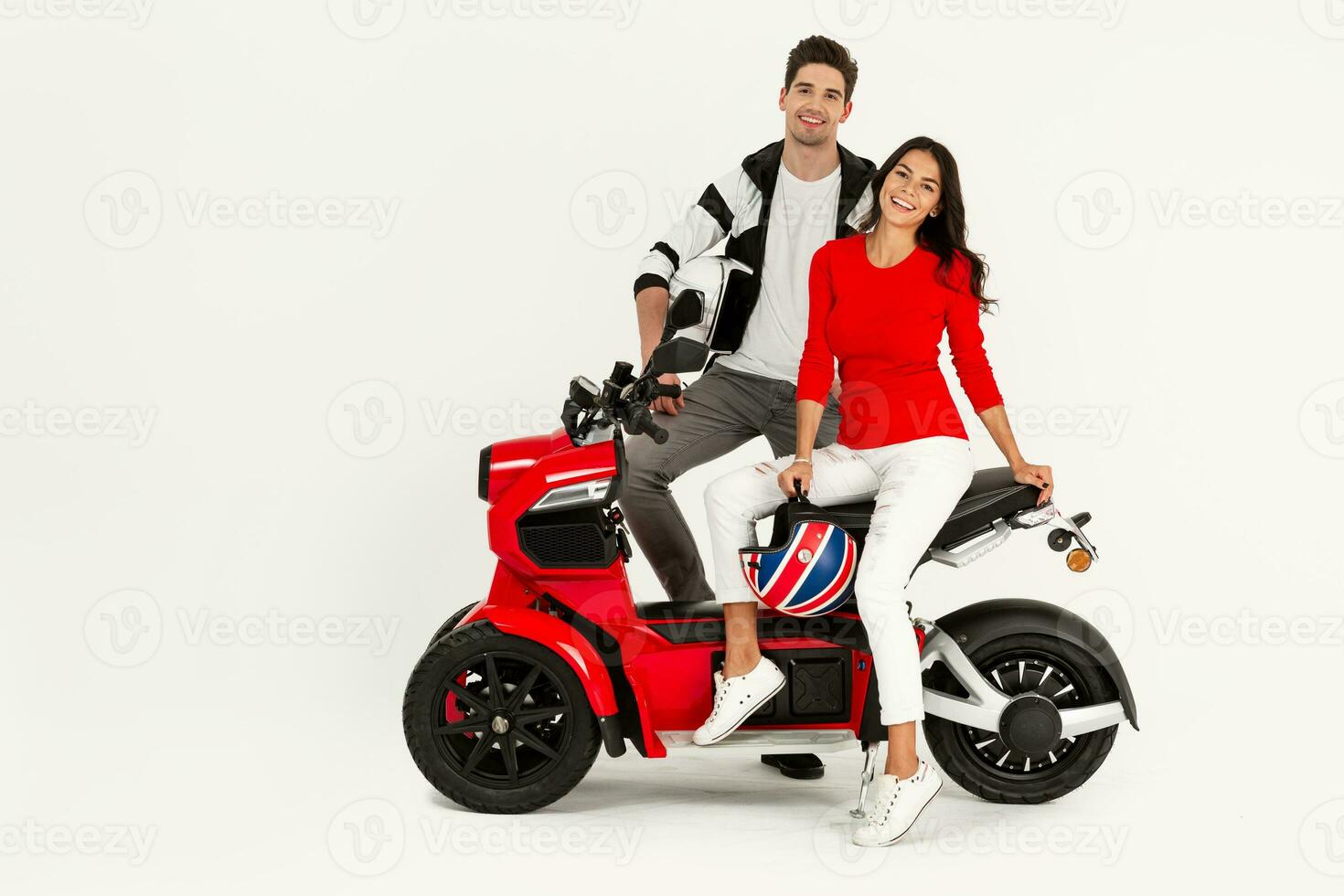 young attractive couple riding an electric motorbike scooter happy having fun together photo