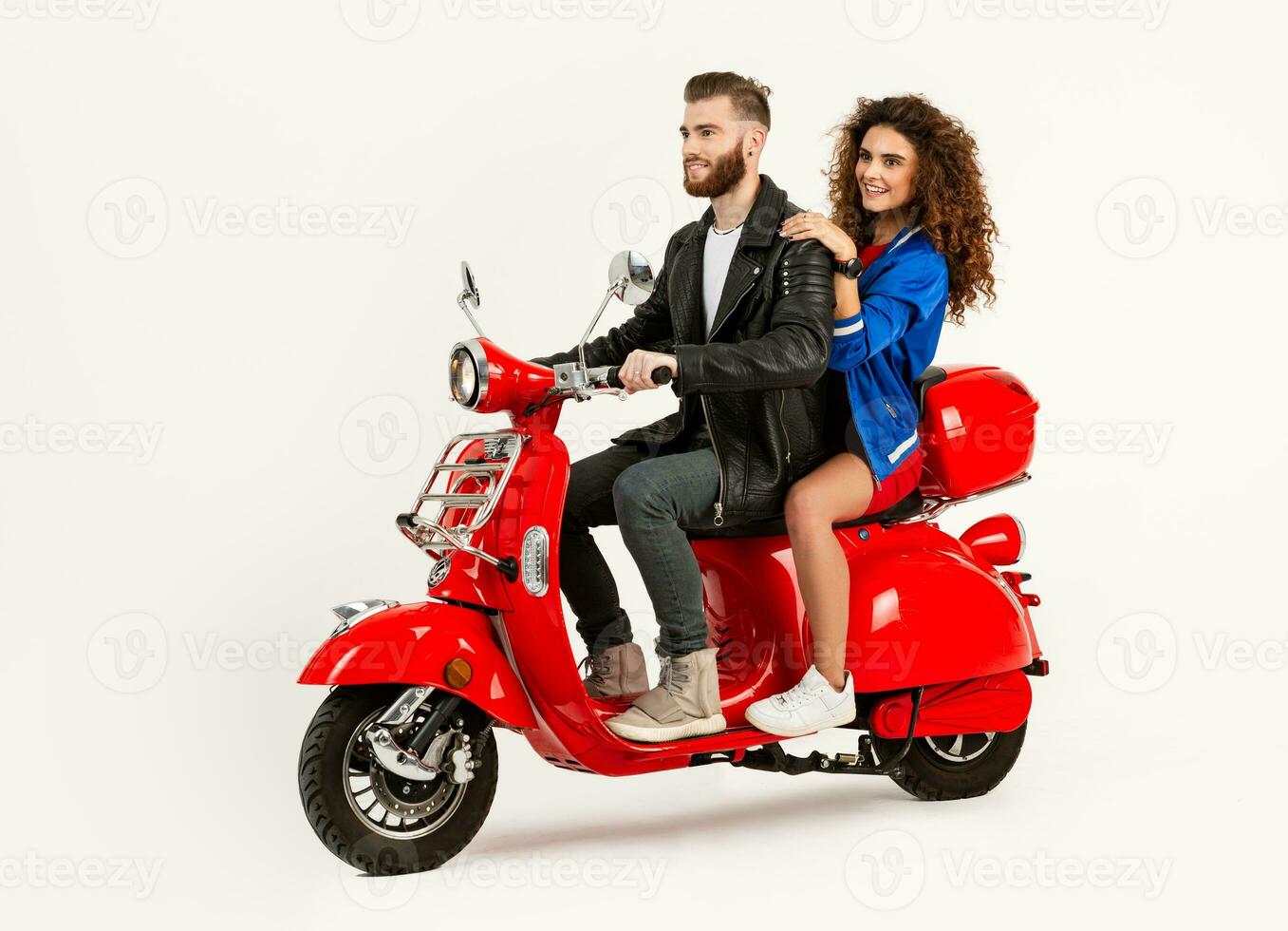 young attractive couple riding an electric motorbike scooter happy having fun together photo