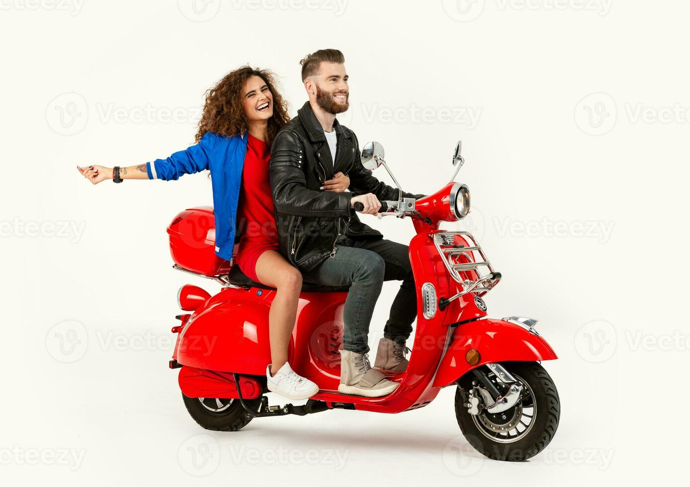 young attractive couple riding an electric motorbike scooter happy having fun together photo