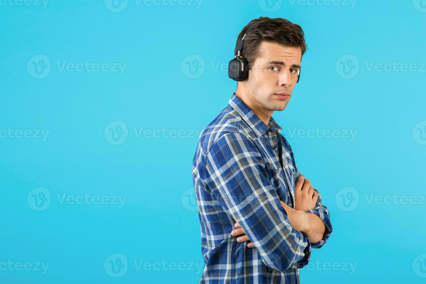 stylish young man listening to music on wireless headphones photo