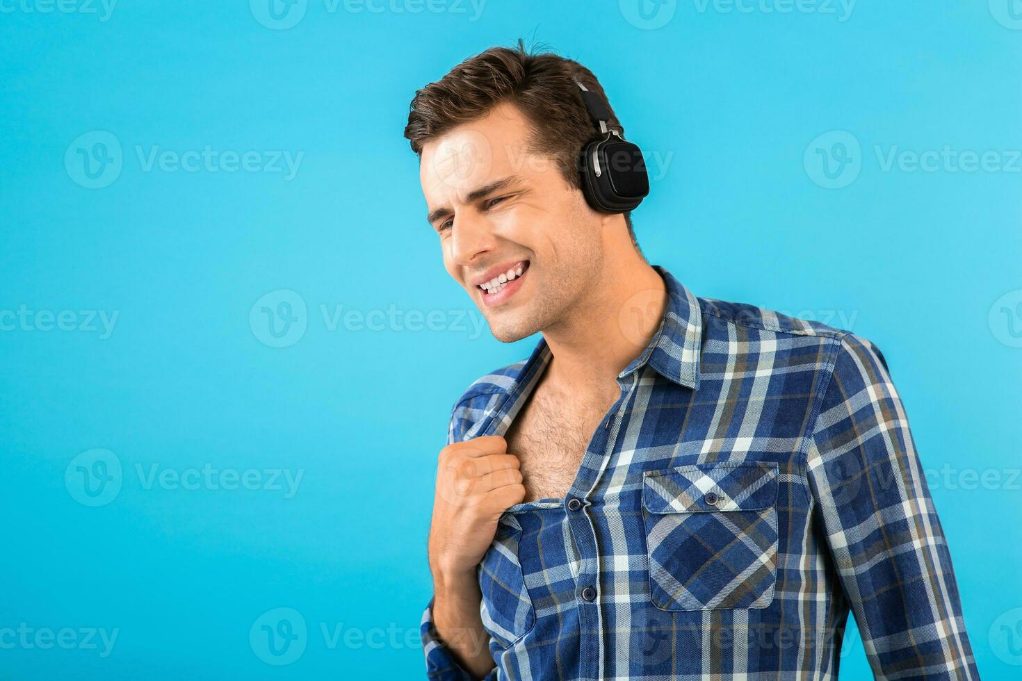 stylish young man listening to music on wireless headphones photo