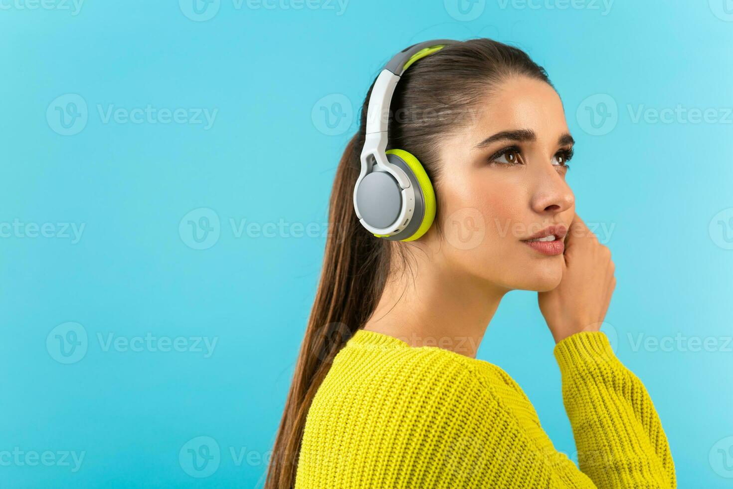 stylish young woman holding listening to music in headphones photo