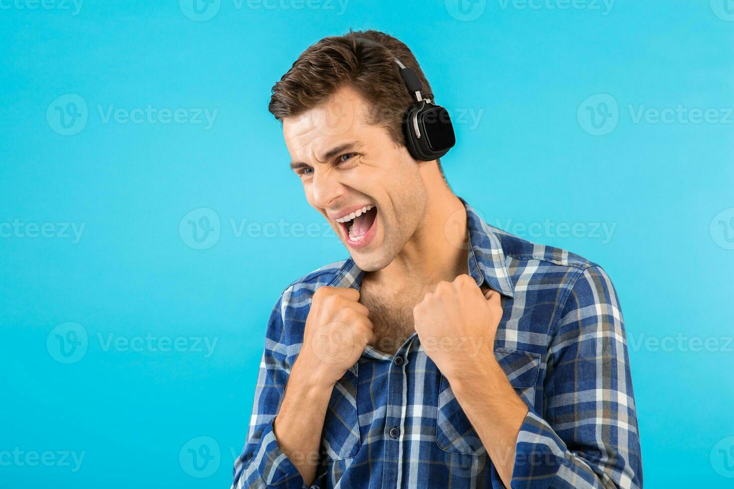 stylish young man listening to music on wireless headphones photo