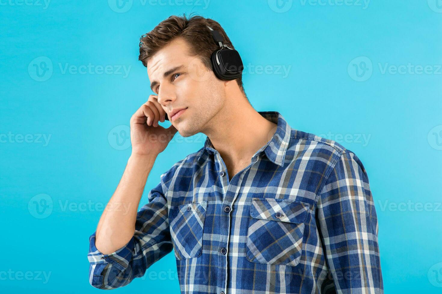 stylish young man listening to music on wireless headphones photo