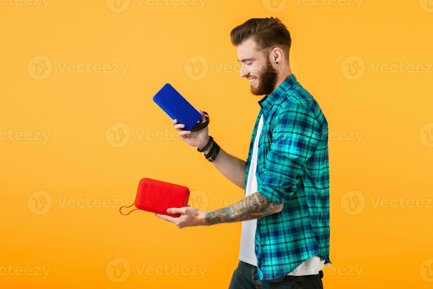 stylish young man holding wireless speakers photo